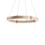 "Modern circular chandelier featuring travertine, iron, and acrylic, with an integrated LED strip emitting a warm glow."