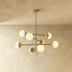 Mid-century modern sputnik chandelier with spherical glass shades on white background, front view with dimensions labeled.