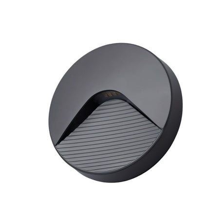 "A sleek, round, minimalist lighting fixture with a clear acrylic diffuser, designed for both indoor and outdoor spaces, providing a soft, focused downward glow."