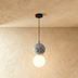 Two-sphere pendant light with textured upper globe and smooth lower sphere, suspended from ceiling mount on white background.