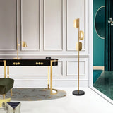 "A gold floor lamp in a luxury interior setting with a console table."