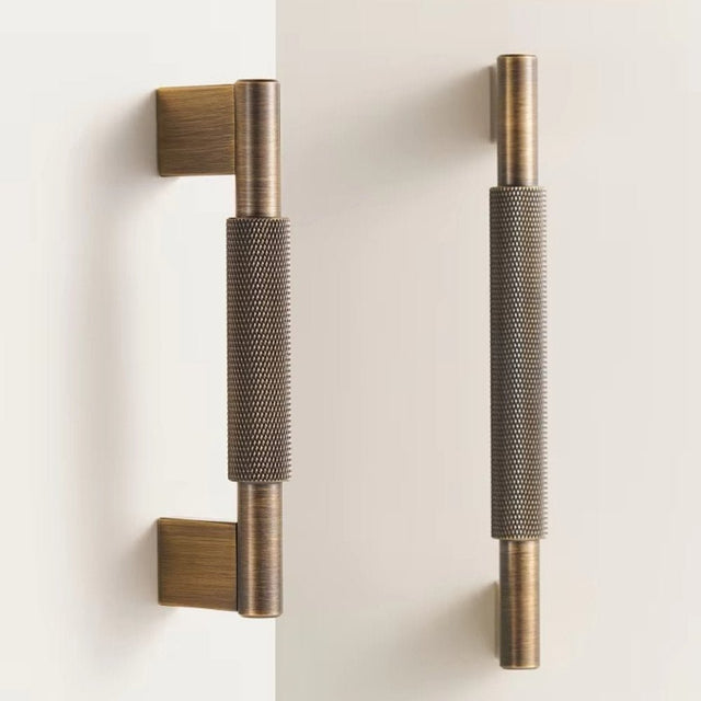 "Pair of antique brass knurled pull bars with clean edges, blending industrial design and functionality for modern spaces."