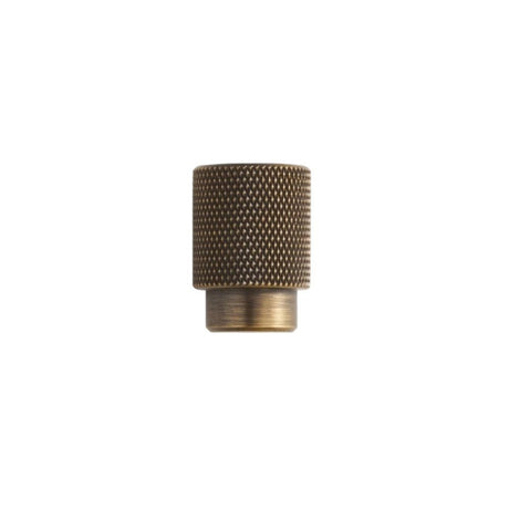 "Small knurled antique brass knob with a cylindrical grip and clean edges, suitable for modern cabinetry and drawers."