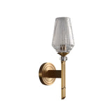 "Modern wall lamp with a copper base, luxurious gold finish, and textured glass shade."