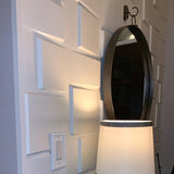 Close-up of Rusan PVC Wall Panels behind a lamp and mirror, showcasing the panel's glossy 3D texture for modern home upgrades.