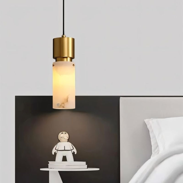 "Modern pendant light with an alabaster shade and copper accents, illuminating a contemporary bedroom."
