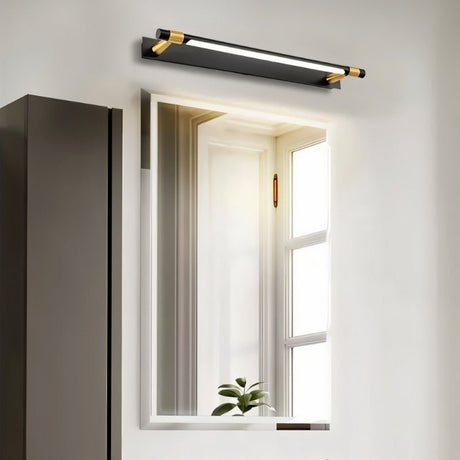 "A modern black and gold wall lamp with an adjustable cylindrical light bar above a rectangular bathroom mirror."