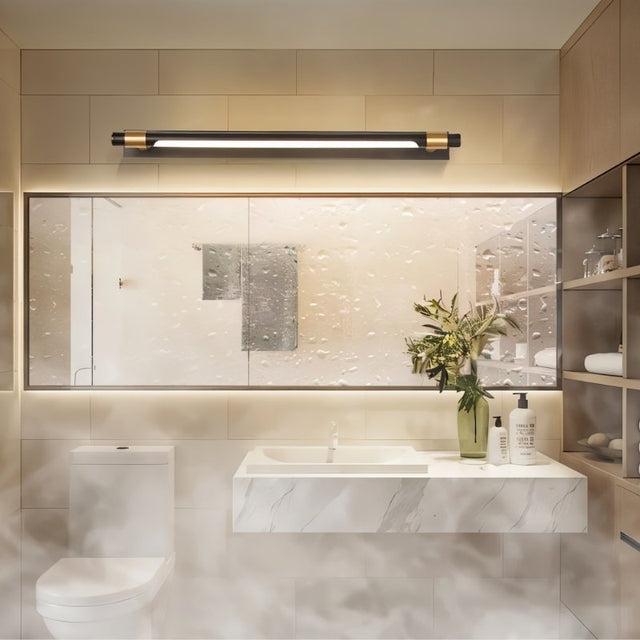 "A modern black and gold wall lamp with a sleek, adjustable cylindrical light bar mounted above a large rectangular bathroom mirror in a contemporary bathroom setting."