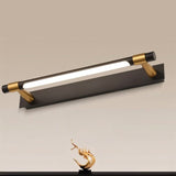 "Close-up of a modern black and gold wall lamp with an adjustable cylindrical light bar, showcasing its sleek design and focused illumination."