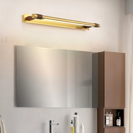 "A modern gold wall lamp with a sleek, adjustable cylindrical light bar mounted above a rectangular mirror in a contemporary bathroom."