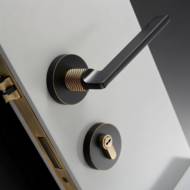 Sabaat Handle and Lock in black with gold knurled grip, combining luxury and function for high-end interior doors.