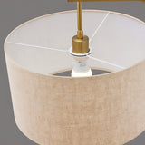 "Close-up of the fabric drum shade with a gold fitting, highlighting the modern iron frame and lighting components of the floor lamp."