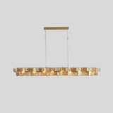 "Isolated iron Salane chandelier with layered amber glass elements, centered on a light grey background."