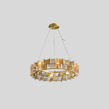 "Round iron Salane chandelier with layered amber glass elements, isolated on a light grey background."