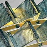 "Close-up of an iron Salane chandelier showing the textured blue glass elements and frame details."