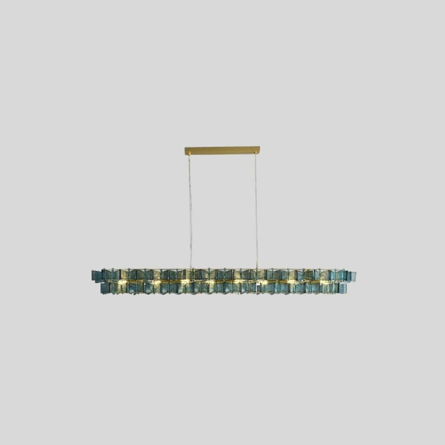 "Isolated iron Salane chandelier with layered blue glass elements, centered on a light grey background."