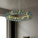 "Round iron Salane chandelier with layered blue glass elements hanging in a modern living room."