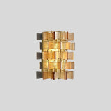 "Isolated iron Salane wall lamp with layered amber glass panels and visible light glow, on a light grey background."