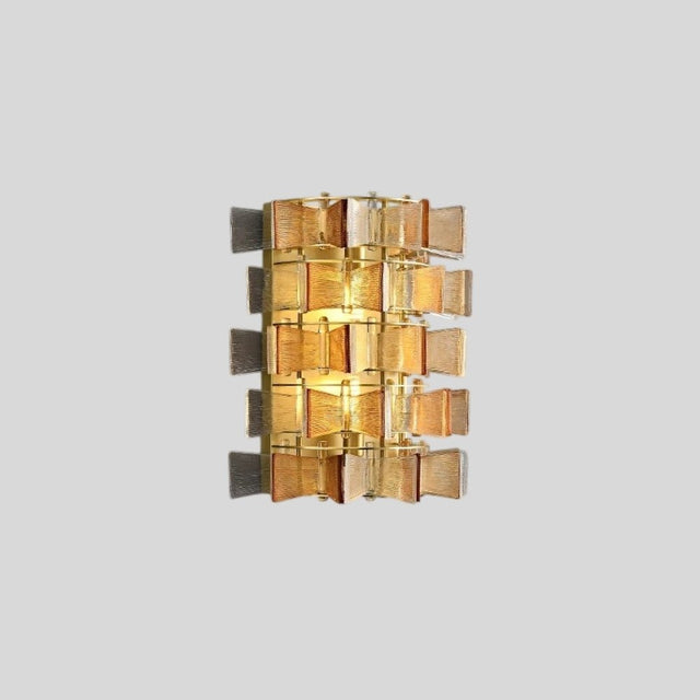 "Isolated iron Salane wall lamp with layered amber glass panels and visible light glow, on a light grey background."