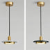 Two pendant lights with brass and black finishes featuring alabaster shades, suspended from ceiling mounts against a neutral background.