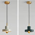 Pendant light with alabaster shade and brass fixture suspended from black cord against white background.
