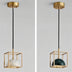 Brass pendant light with white alabaster globe shade suspended from black cord against white background.