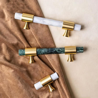 "Pair of luxurious marble handles with polished brass accents, showcasing their elegant design for contemporary and classic interiors."