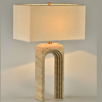 "Modern table lamp with an arched travertine base and a rectangular fabric shade"