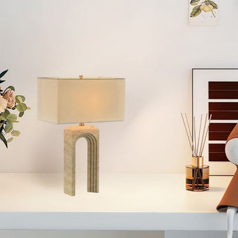 "Elegant table lamp with an arched travertine base and fabric shade styled on a modern office desk"