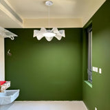 "Sculptural pendant light with a wave-like frame and acrylic diffuser creating a statement piece in a contemporary space."