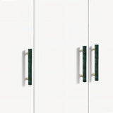 "Modern green marble and brass pull bars on a minimalist white cabinet, showcasing elegant hardware."
