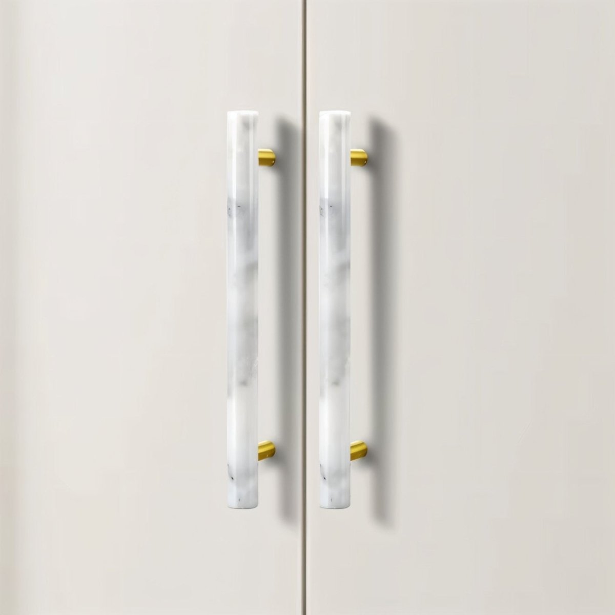"Close-up of a marble and brass pull bar on a white cabinet, showcasing its elegant design."