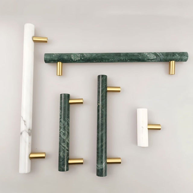 "Collection of marble and brass knobs and pull bars in various sizes and colors, showcasing modern hardware."