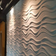 Serfa Wall Panel with 3D wave design installed on an interior wall, ideal for modern PVC wall panel decor.