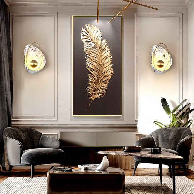 "Pair of modern resin wall lamps with shell shapes, flanking a gold feather wall art in a living room."