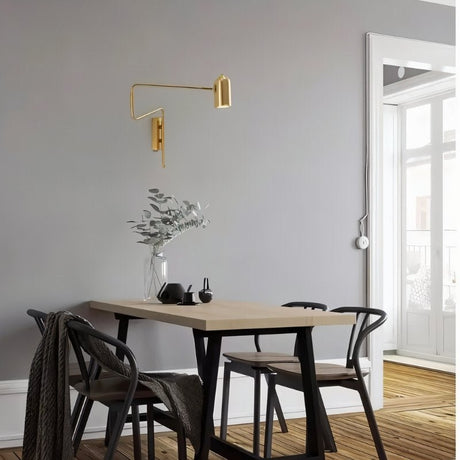 "Gold adjustable arm bedside reading lamp mounted on a dining room wall."
