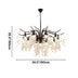 Black metal chandelier with cascading clear crystal prisms hanging from curved branches against white background.