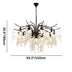 Black metal chandelier with cascading clear crystal glass drops, 43.3" wide and 25.5" high, on white background.