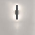 Modern black vertical wall sconce with integrated LED lighting against a neutral white wall.