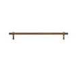 "Long antique brass pull bar with cylindrical design and subtle accents, isolated on a white background."