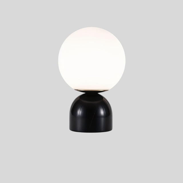 Sibwa Table Lamp with black marble base and white globe, perfect for sleek and modern living room or office lighting.