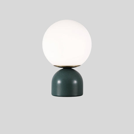 Sibwa Table Lamp with green base and white globe on grey background, ideal for modern ambient lighting in any room.