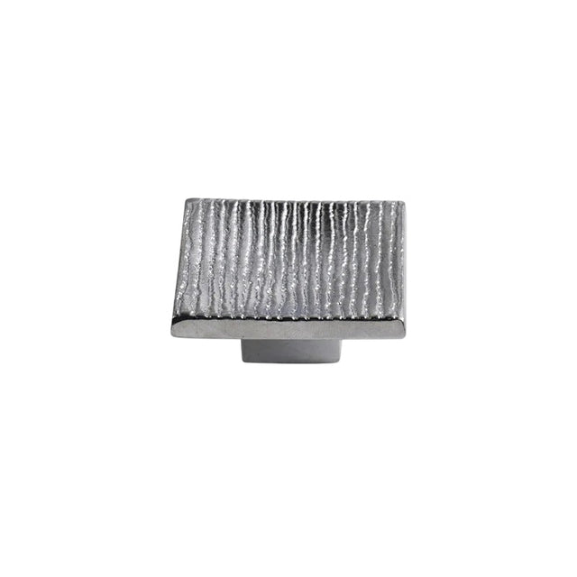 "Studio shot of a single silver square cabinet knob with a ridged, textured surface on a white background."