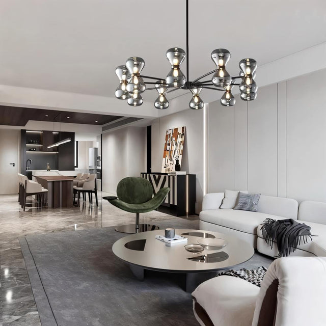 "Black iron Silvine chandelier with smoked glass spherical shades hanging above a modern living room with a white sofa and round coffee table."