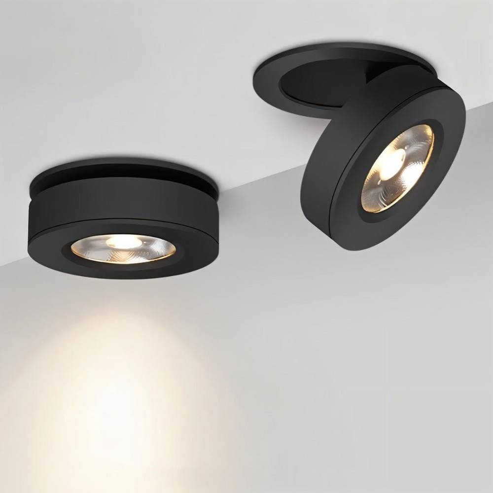 Two black recessed ceiling downlights with warm LED bulbs mounted on a white ceiling.