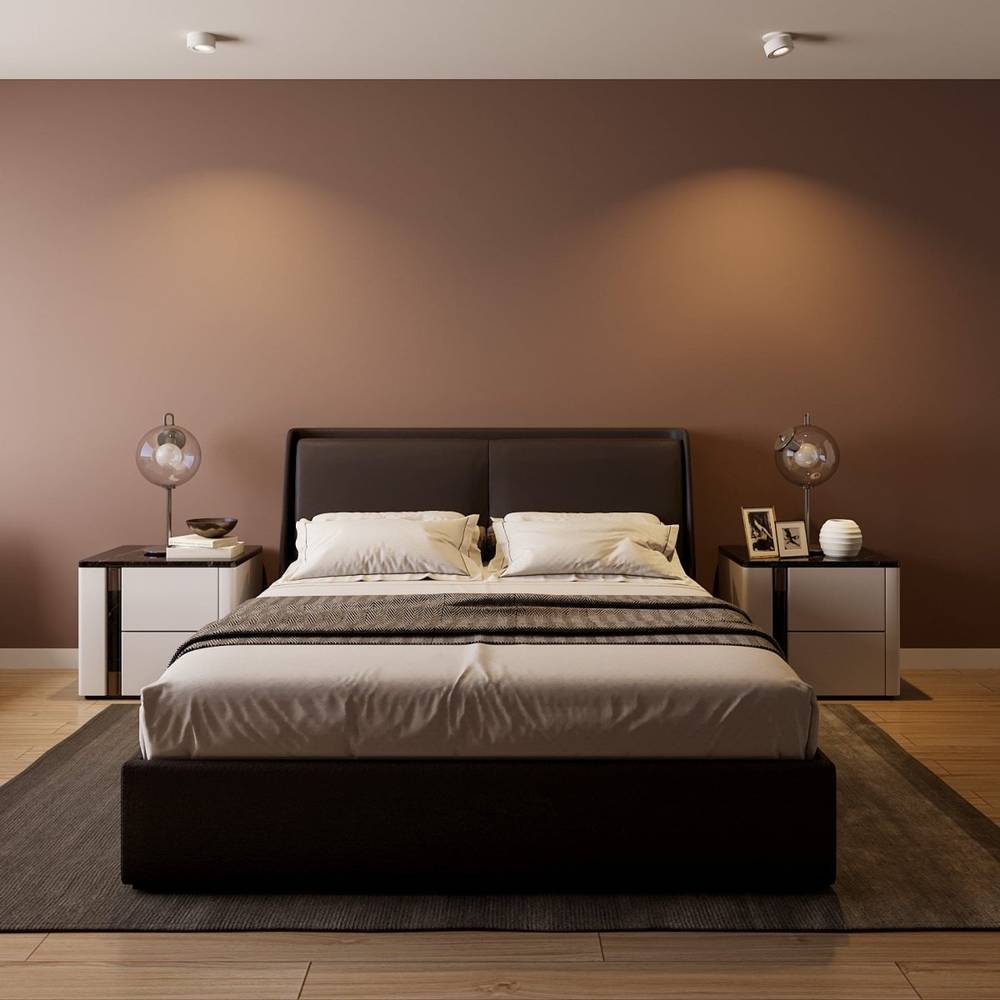 Modern bedroom with black bed frame, cream pillows, and chrome pendant lights against warm taupe wall.