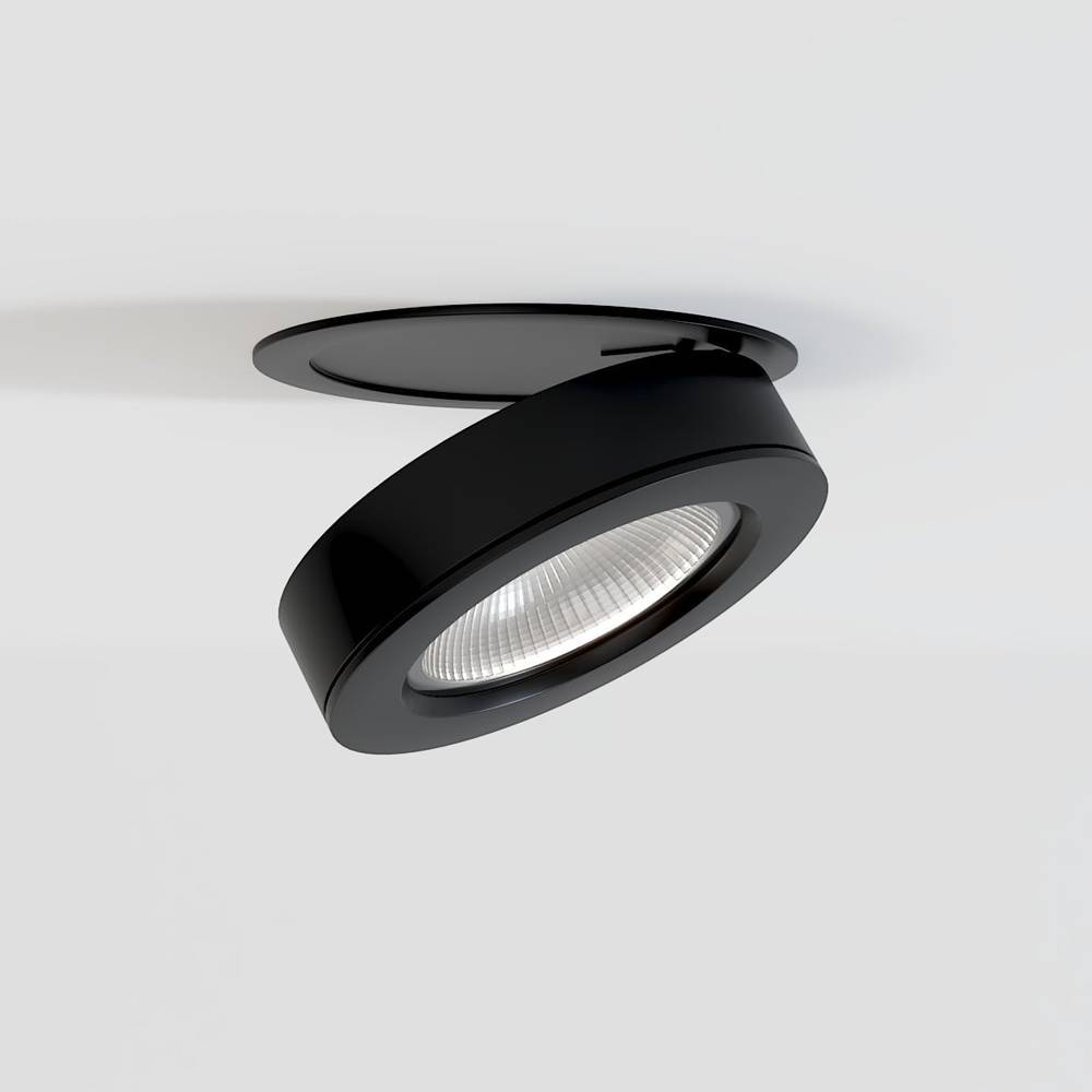 Black adjustable recessed downlight with reflector lens mounted in white ceiling.