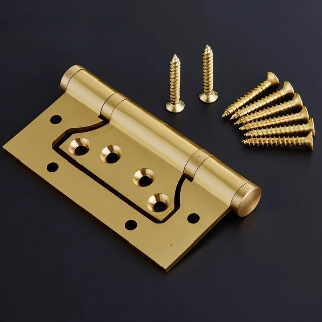 "A gold brass door hinge with screws on a dark background."