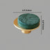 Green marble cabinet knob with brass base on gray background.