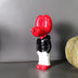 Red and black glossy figurine with boxing gloves on white base against gray background.